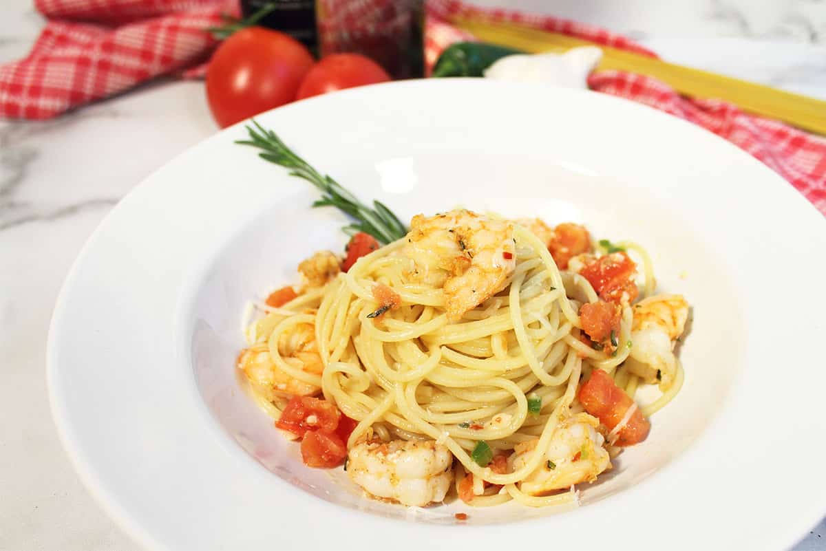 Serving of cajun pasta with shrimp in white bowl.