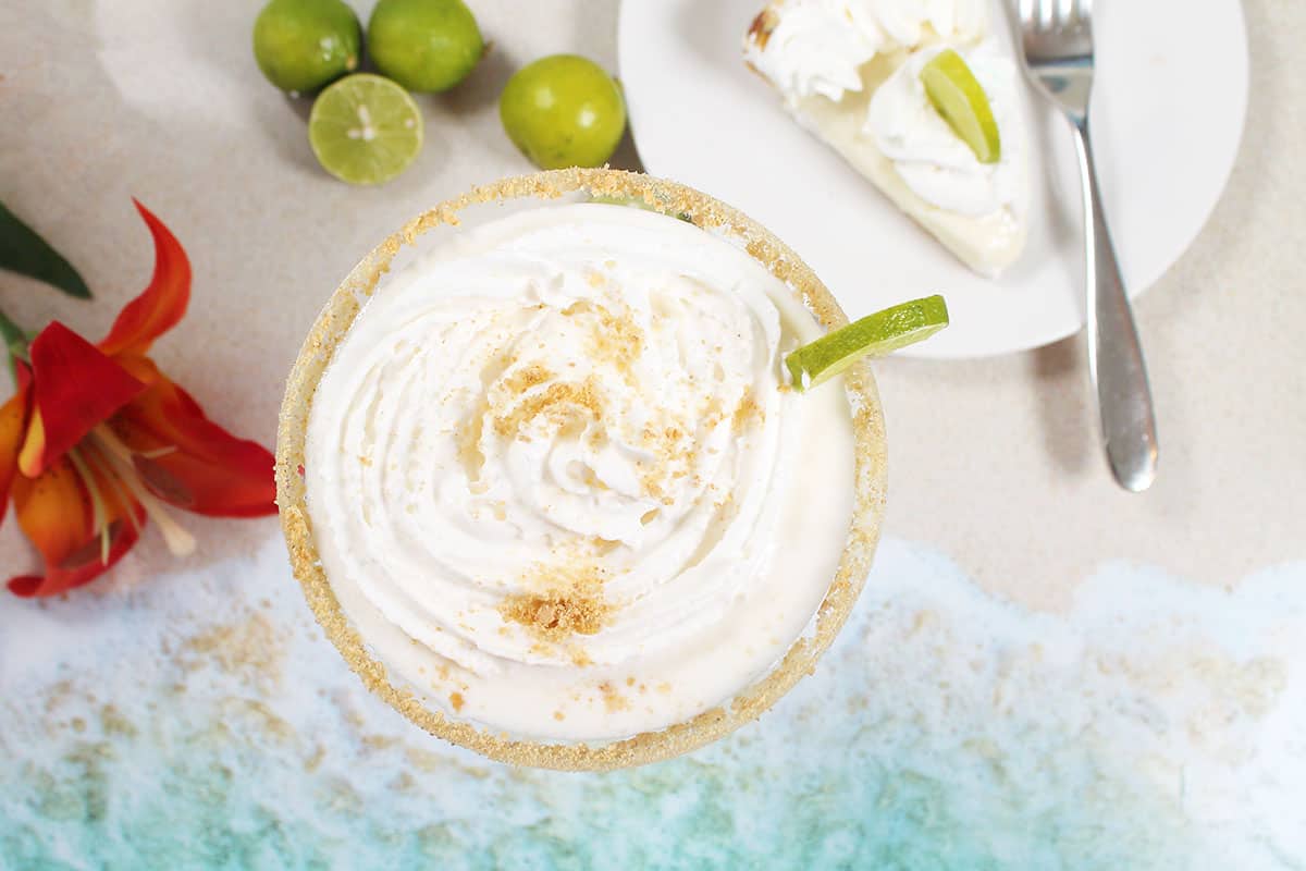 Overhead of key lime pie martini with vanilla vodka and whipped cream.