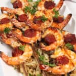 Closeup of grilled skewers on bed of rice.