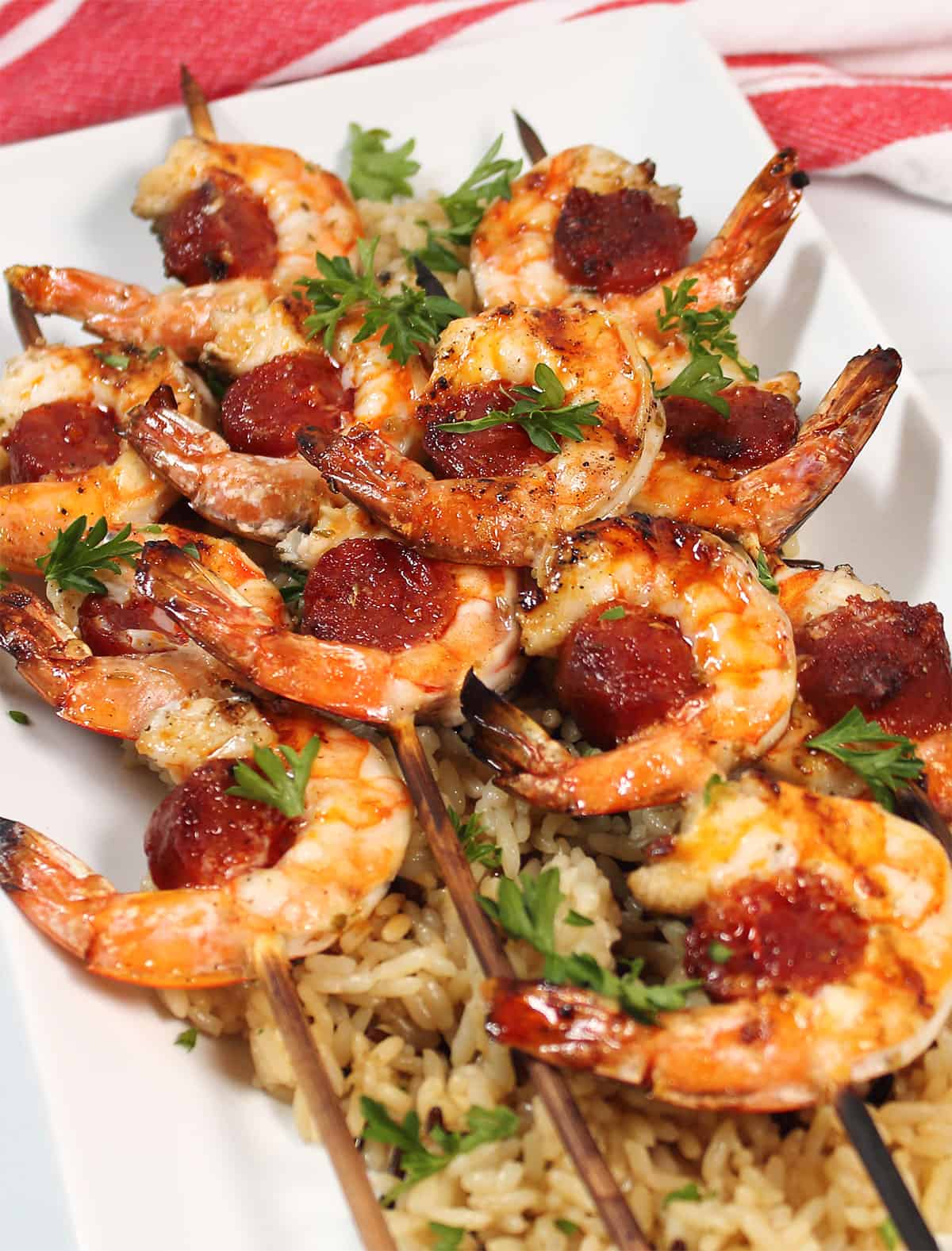 Skewers of shrimp and chorizo on bed of rice.
