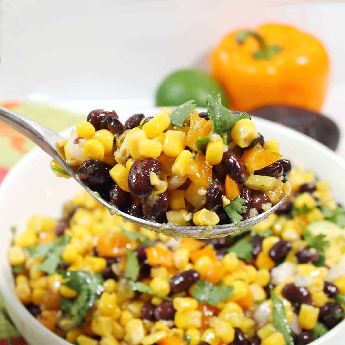 Closeup of spoonful of corn and black bean salad.