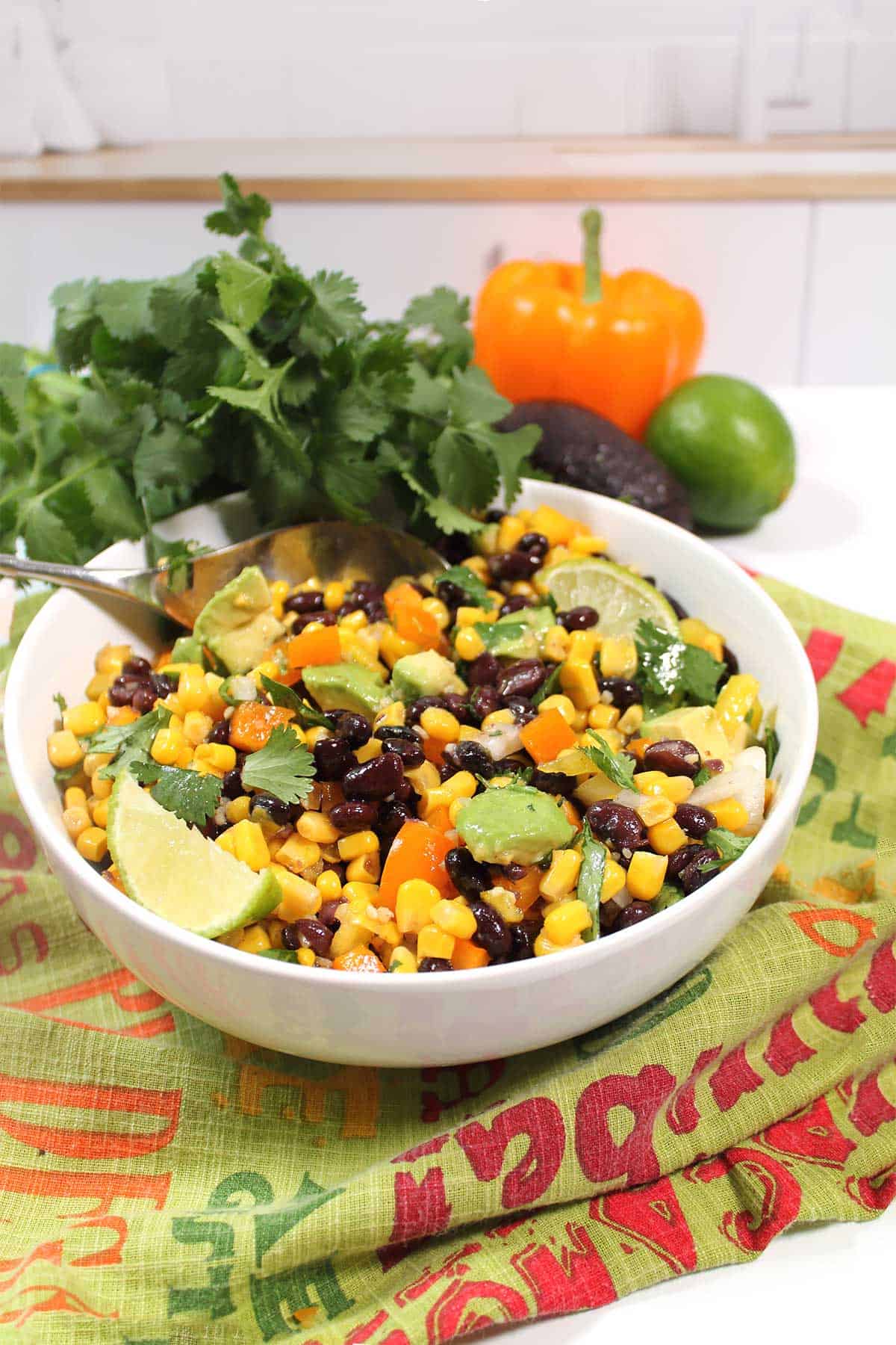 Southwestern black bean salad on counter with spoon ready to serve.