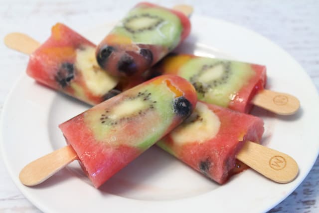 Fruit Popsicles on white plate.