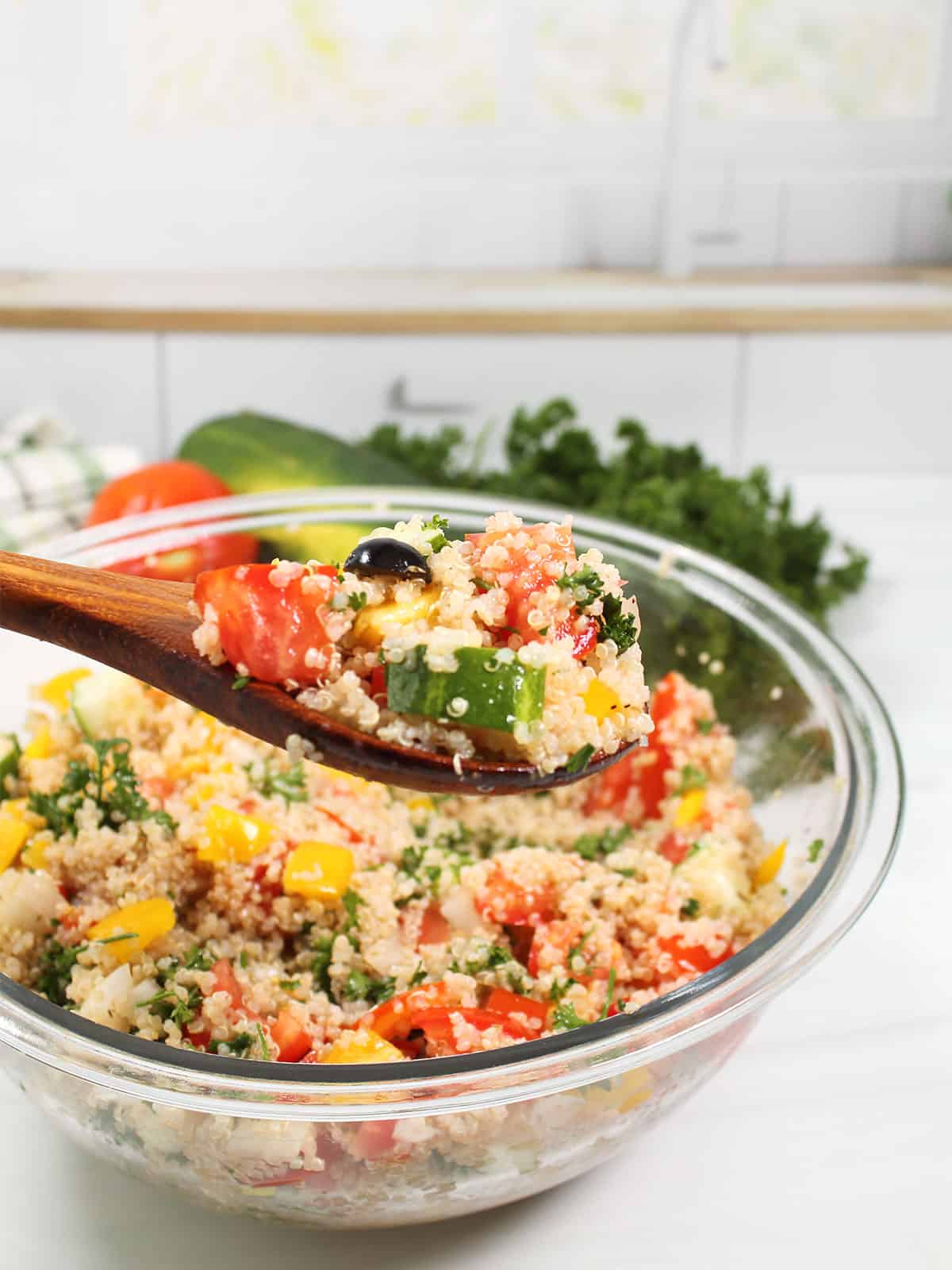 Spoonful of Quinoa Tabbouleh over bowl.