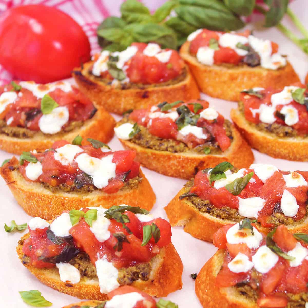 Pesto Bruschetta on parchment paper.