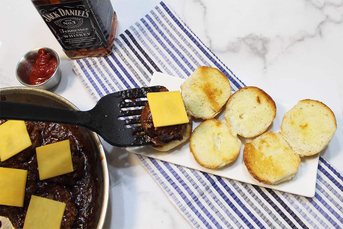 Placing sliders on toasted buns.
