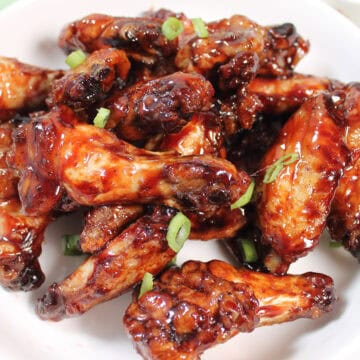Closeup of Asian sticky wings in bowl.