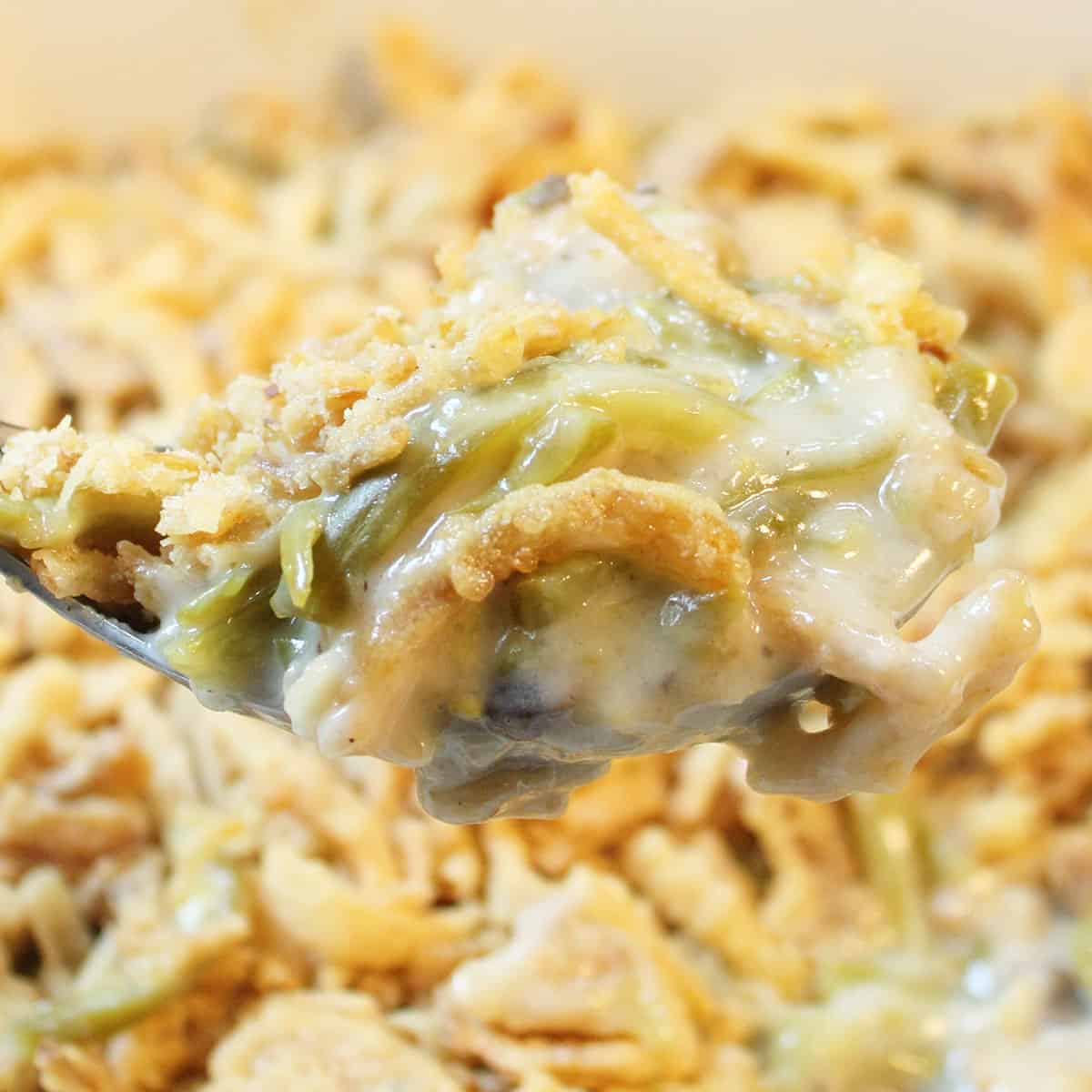 Closeup of spoonful over hot casserole.