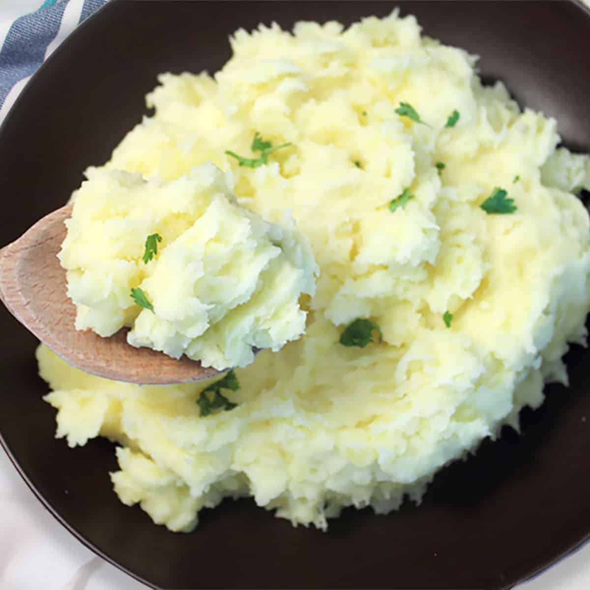 Closeup of spoonful of mashed potatoes.