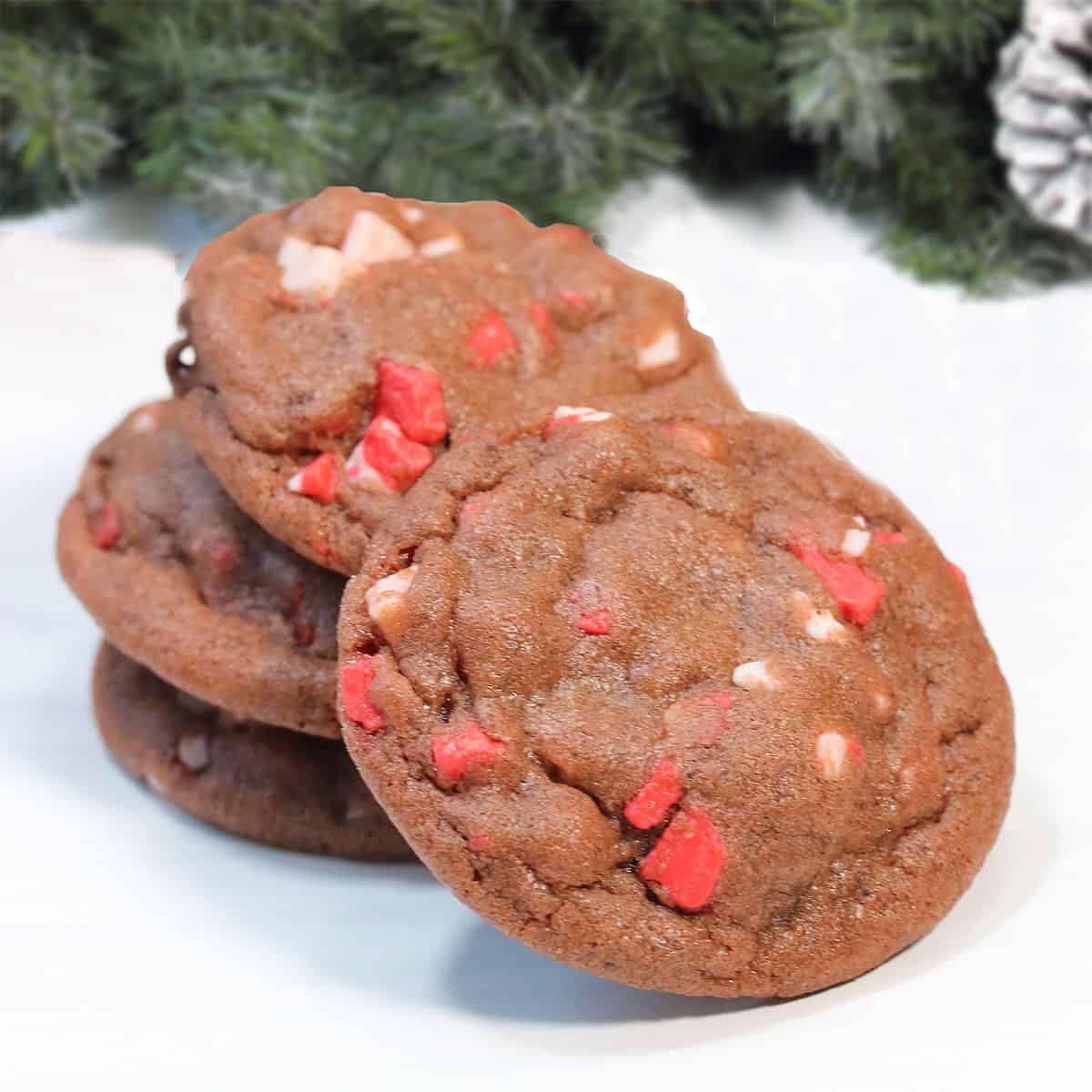 Chocolate Peppermint Chip Cookies stacked with one leaning.
