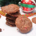 Stacked chocolate peppermint chip cookies with ornament.