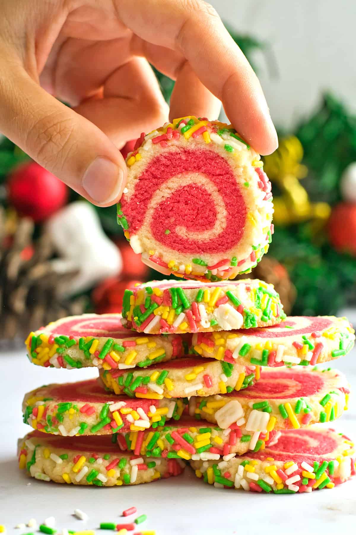 Holding pinwheel cookie on top of stack.