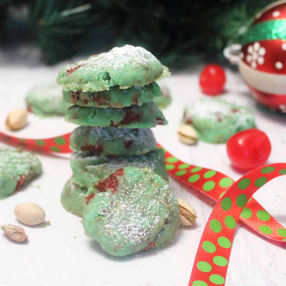 Stack of pistachio meltawaycookies with polka dot ribbon.