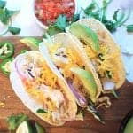 Overhead of tacos on board with fixings.
