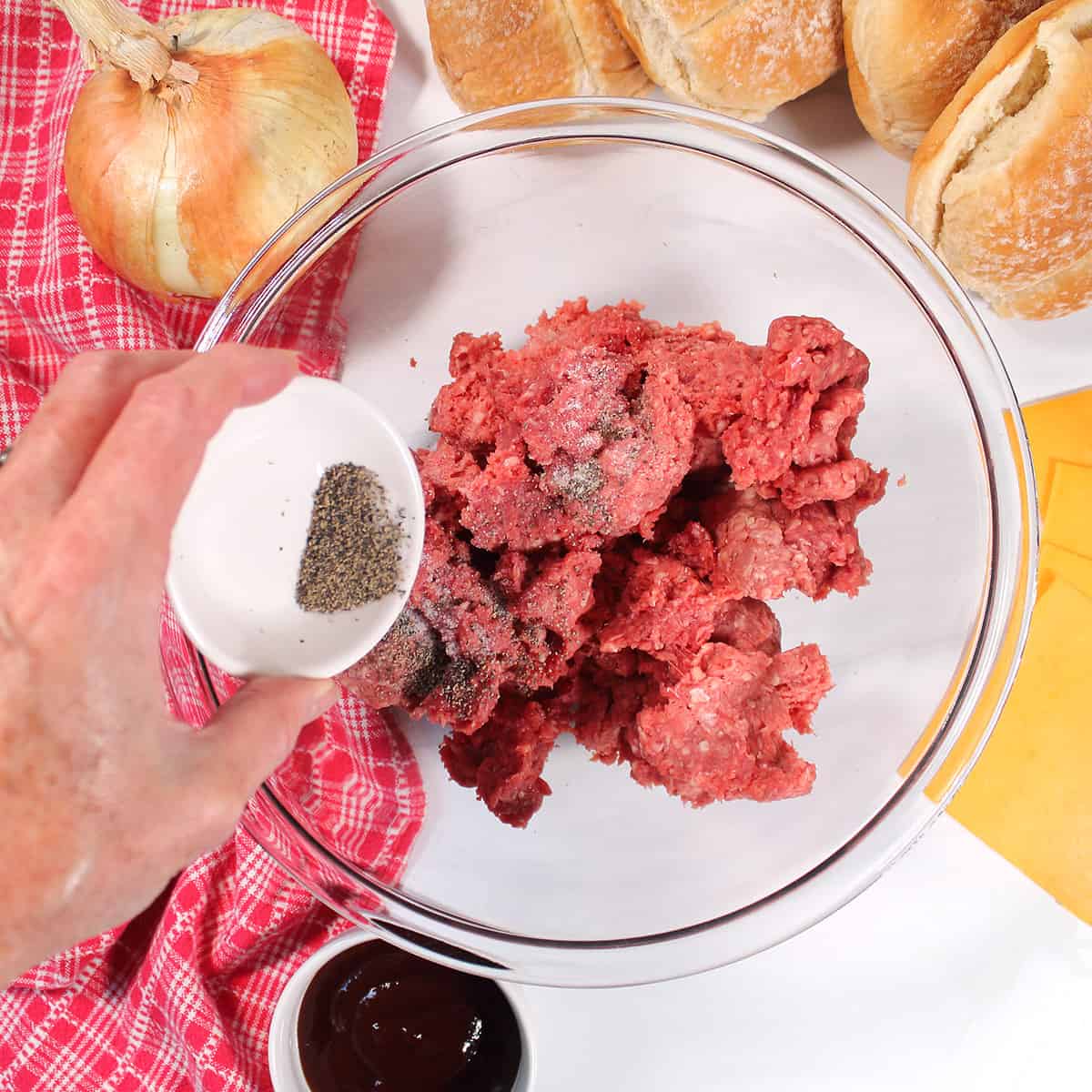 Seasoning meat with salt and pepper.
