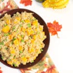 Overhead of partial bowl of pilaf on fall towel.