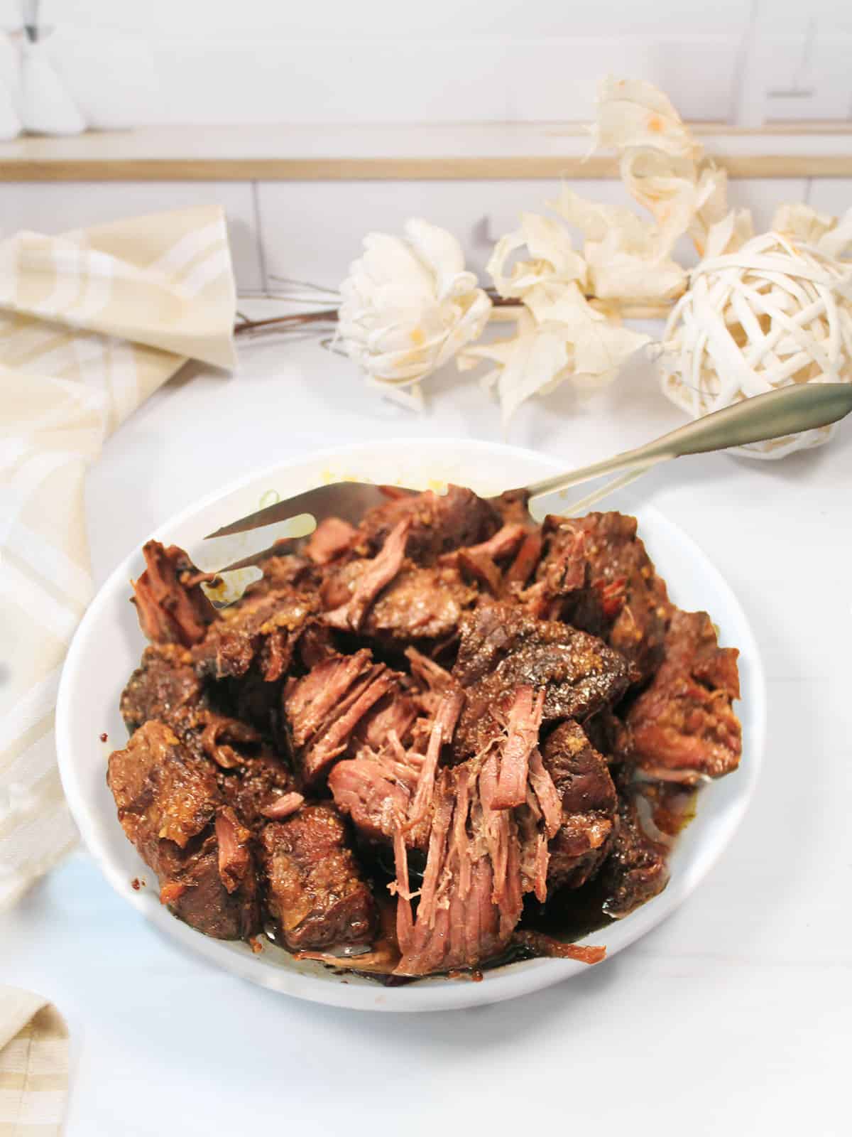 Tender fall apart short ribs in serving bowl.
