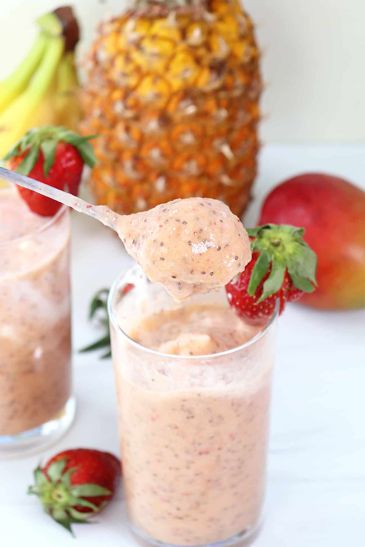 Spoonful of tropical fruit smoothie.