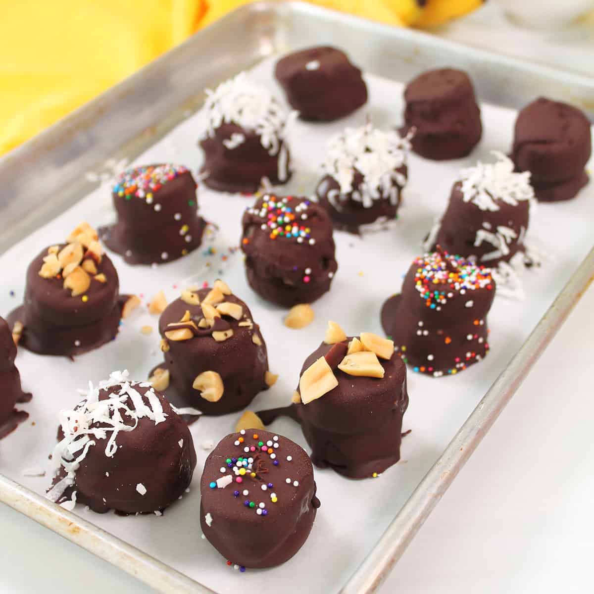 Frozen Chocolate Peanut Butter Banana Bites on baking sheet.