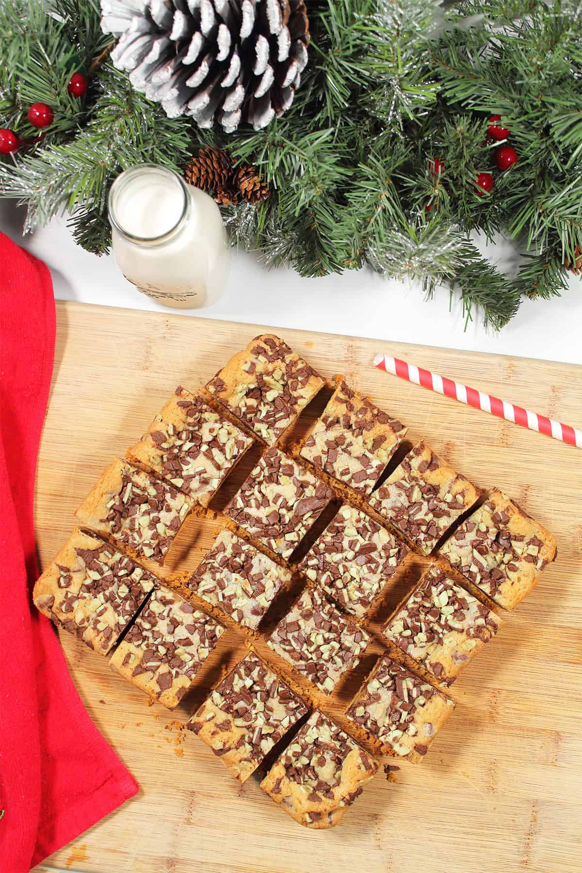 Cut chocolate mint bars on wooden cutting board.