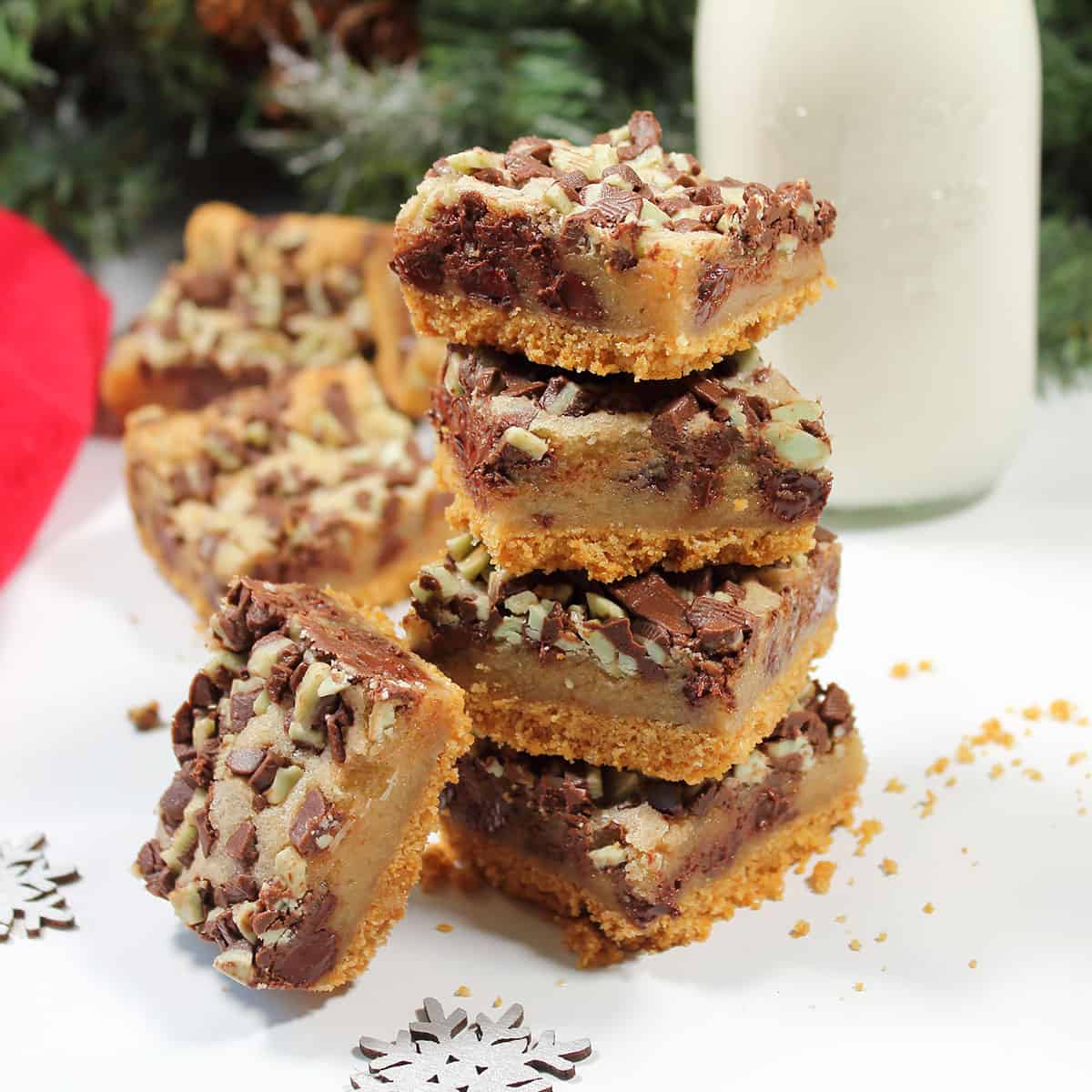 Stacked cookies by milk bottle.