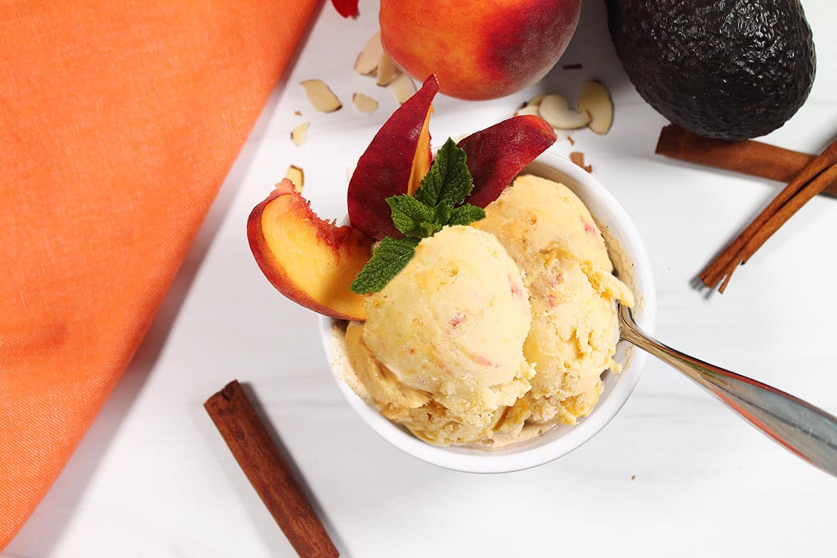 Overhead of peach frozen yogurt in bowl.