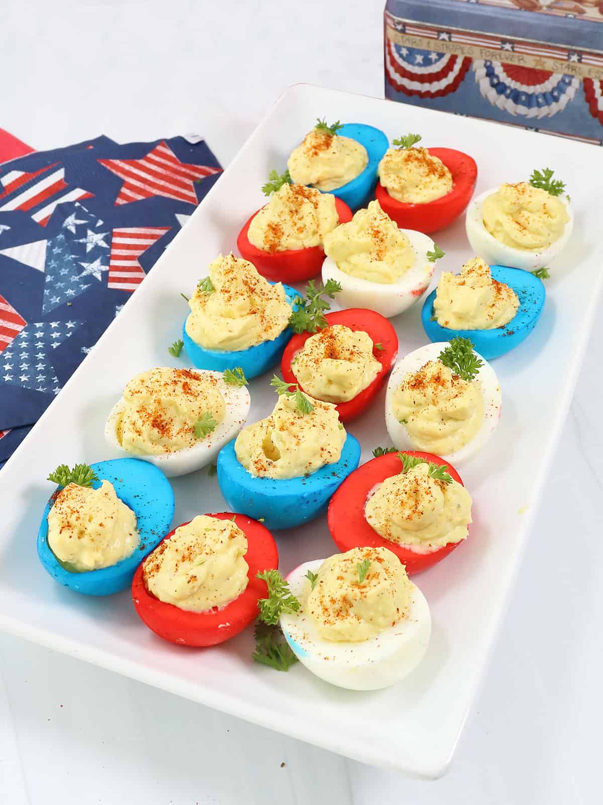 Red White and Blue Deviled Eggs on white platter.
