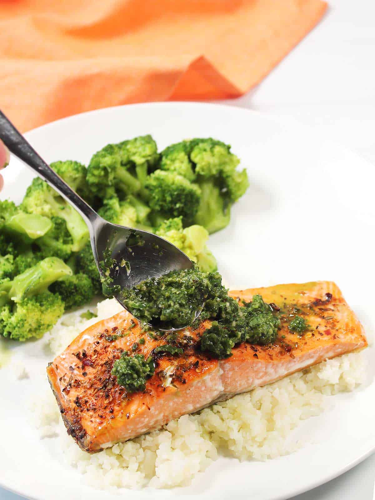 Spooning sauce over salmon.