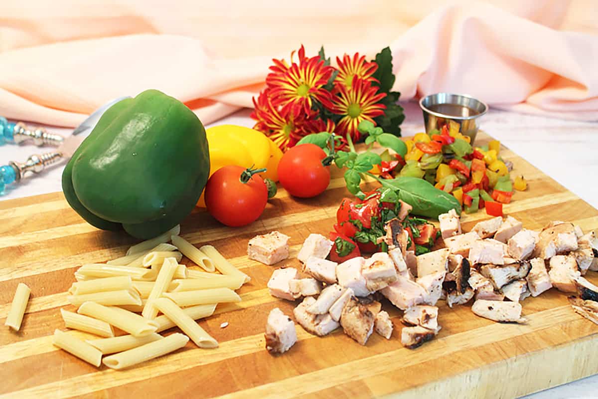 Chicken Pasta Salad ingredients on wooden cutting board.