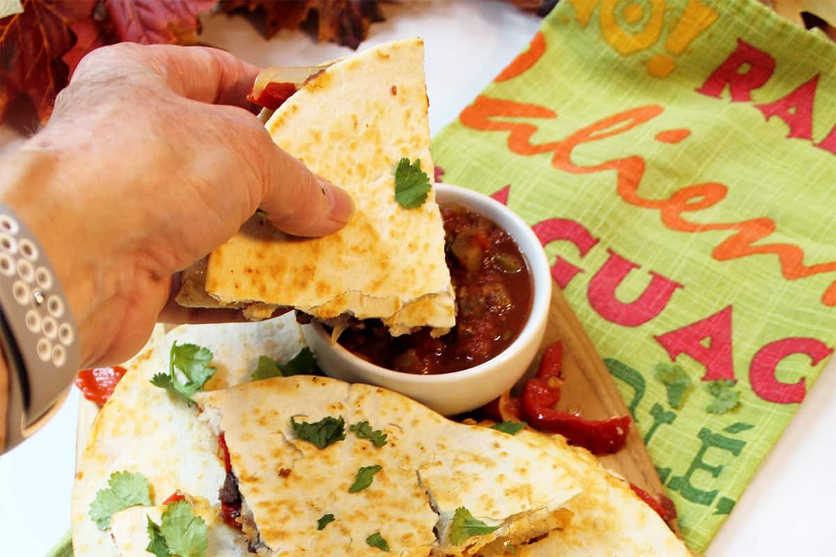 Dipping quesadilla into salsa.
