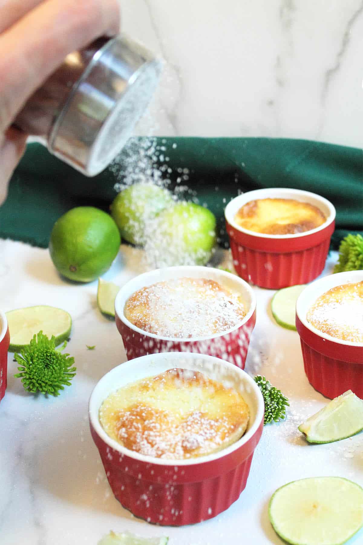 Sprinkling powdered sugar on pudding cakes.
