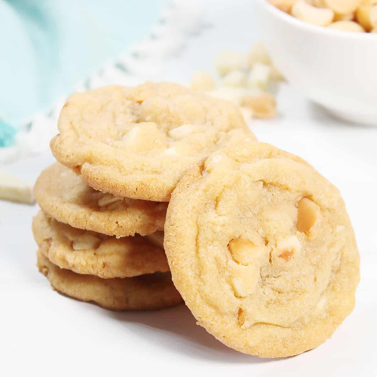 White Chocolate Macadamia Nut Cookies stacked with one leaning.