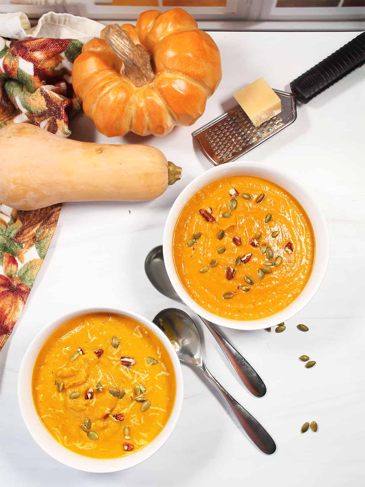 Two bowls of Autumn Squash Soup overhead.
