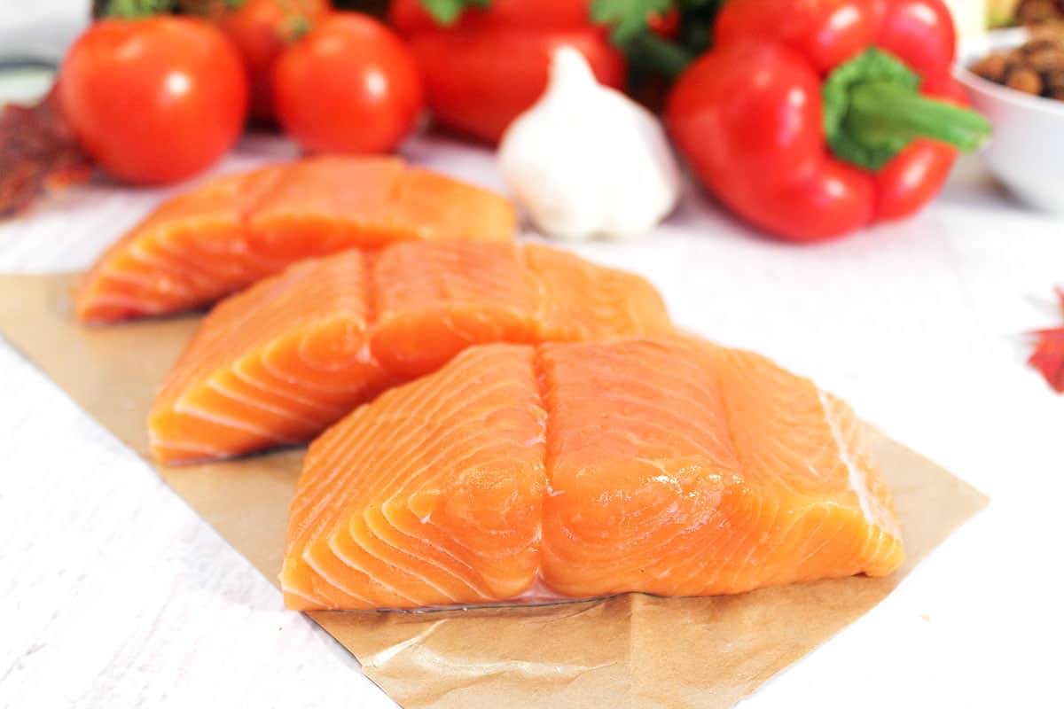 Closeup of raw salmon on marble table.