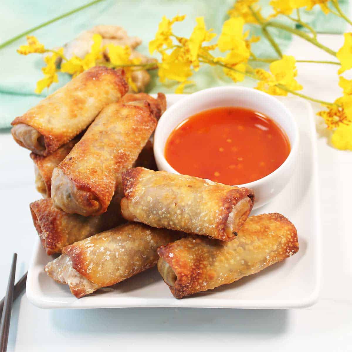 Air Fryer Vegetable Egg Rolls on plate with sweet chili dipping sauce.