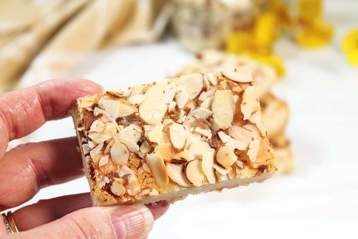 Holding an almond cookie bar.