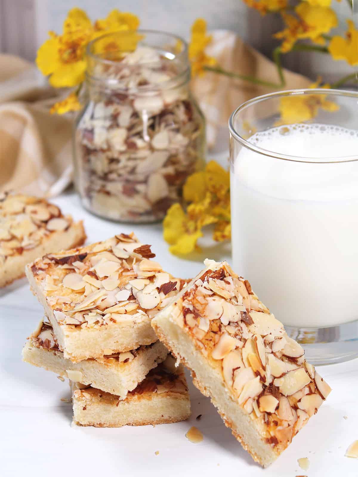 Almond Bars with almond paste on table next to milk.
