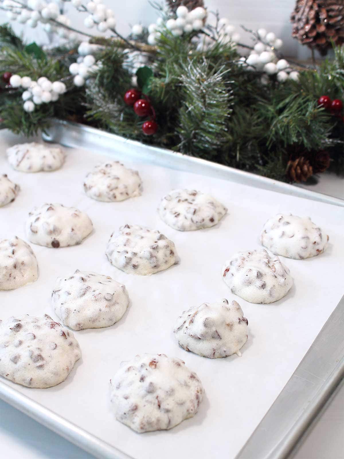 Baked meringue cookies after 8 hours on parchment lined cookie sheet.
