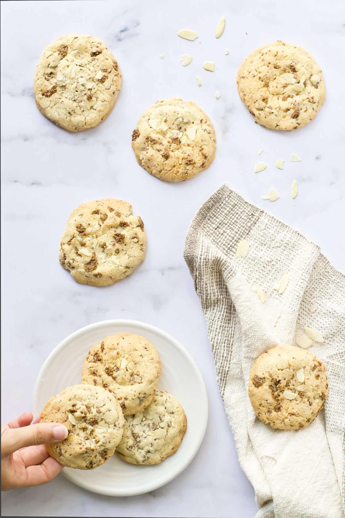 Picking up Special K cookies with beige napkin.