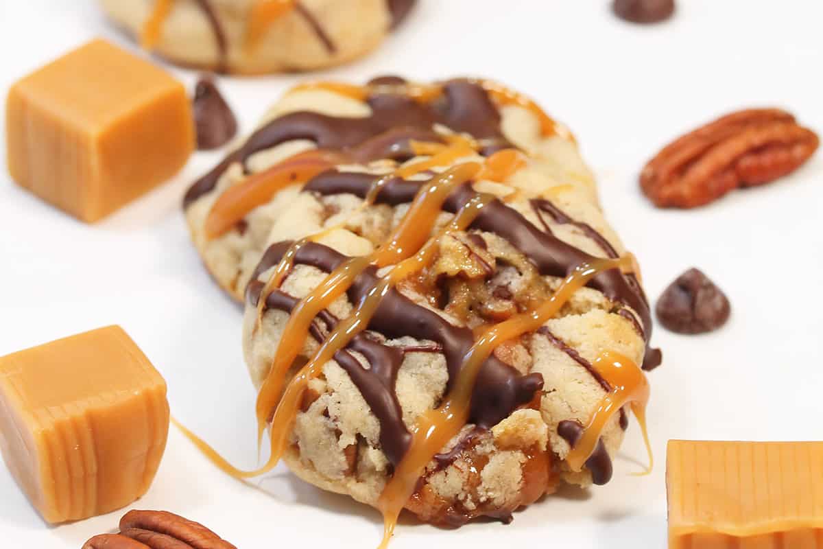 Turtle cookies scattered on table with caramels.