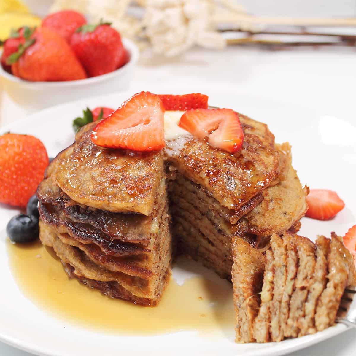 Forkful of stacked pancakes.