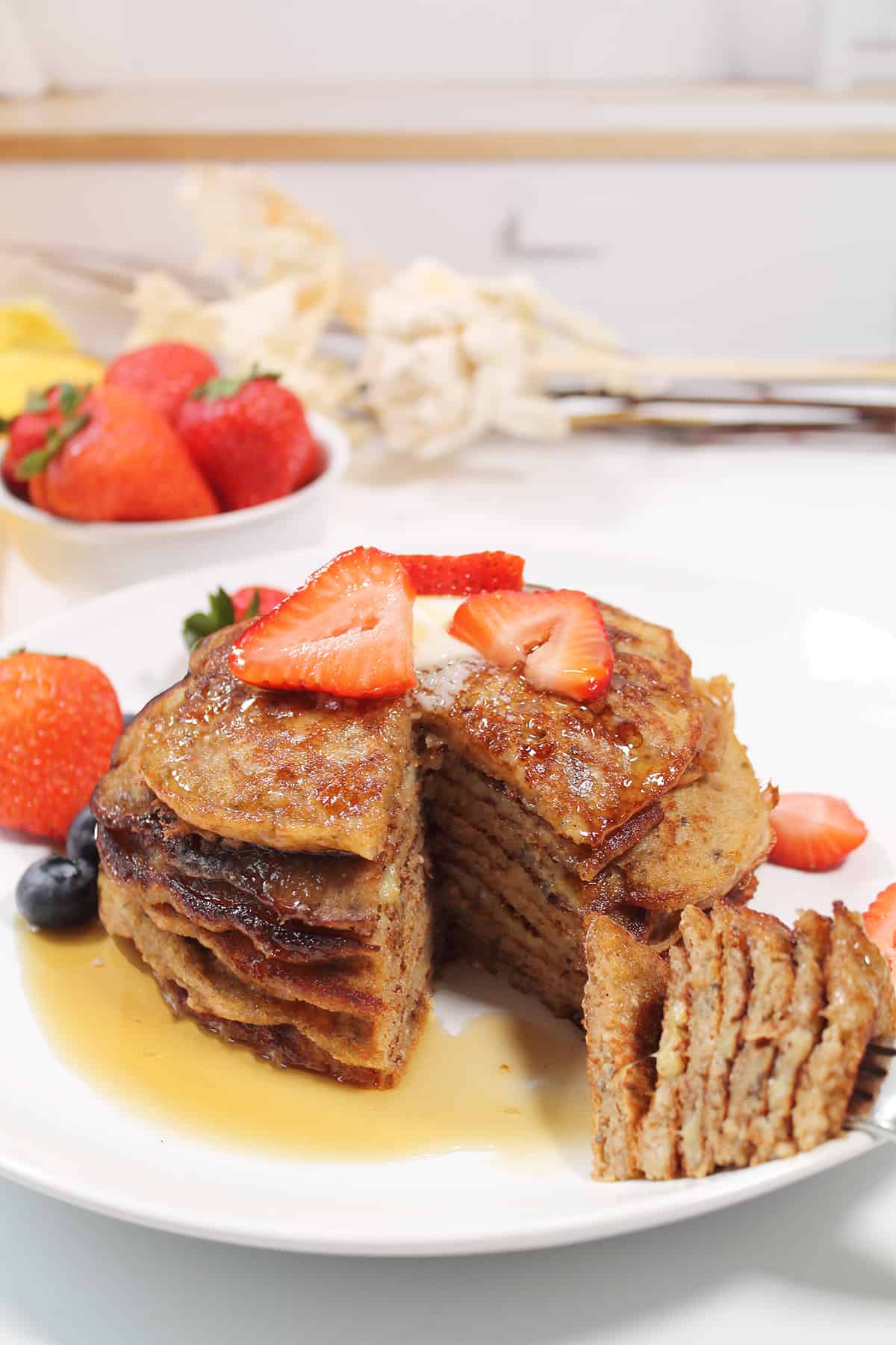Forkful of pancakes with syrup.