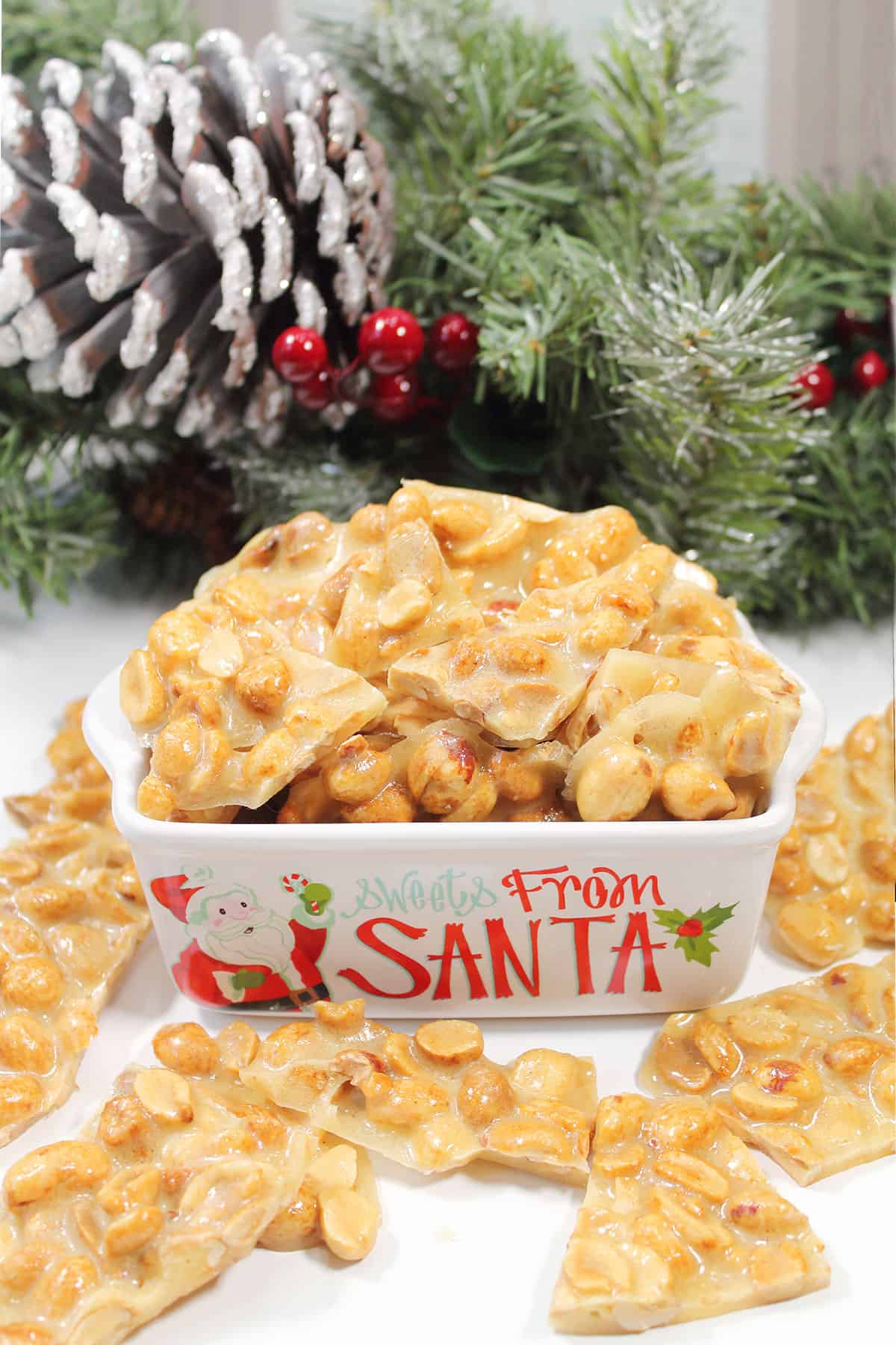 Microwave peanut brittle piled into a Christmas dish.