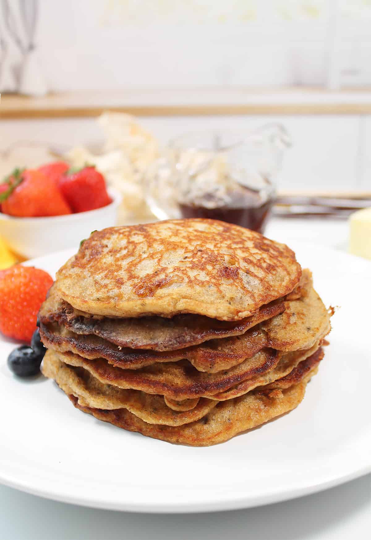 Stack of cooked pancakes on plate.