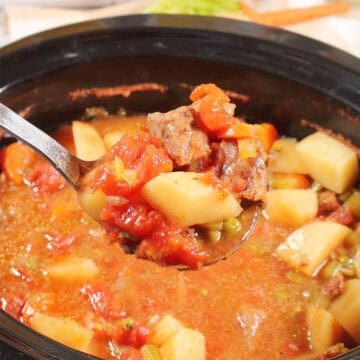 A ladle of easy beef stew in crock pot.