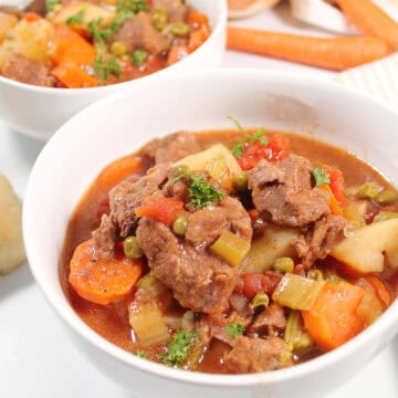 Two bowls of Crock Pot Old Fashioned Beef Stew with vegetables and potatoes.