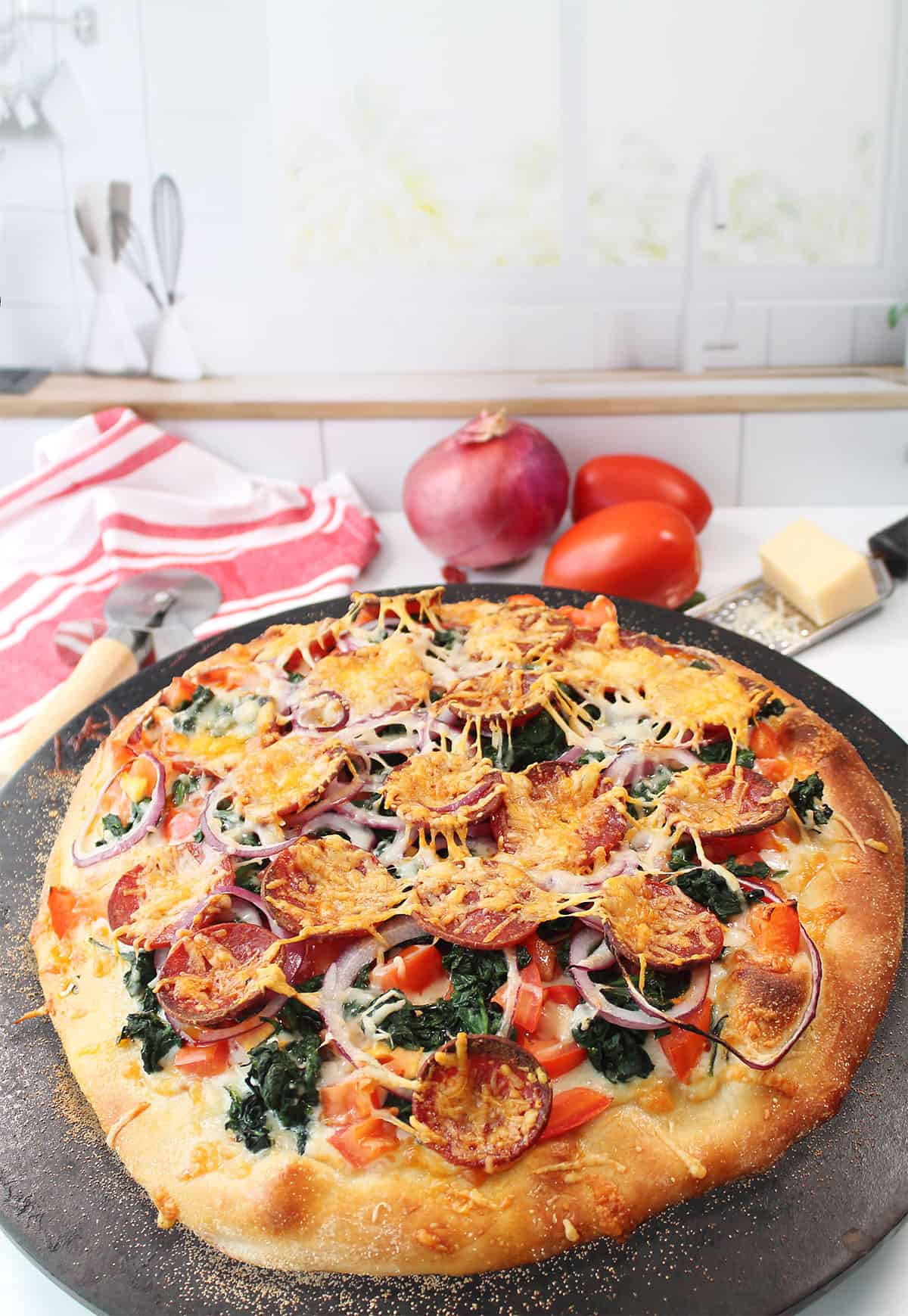 Baked chorizo pizza on pizza stone.