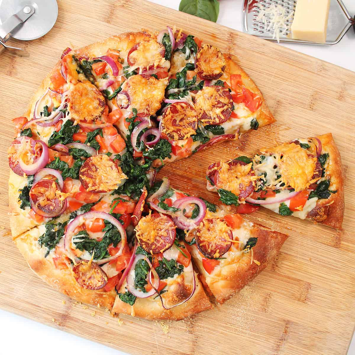 Overhead of Manchego and chorizo pizza with slice pulled out.