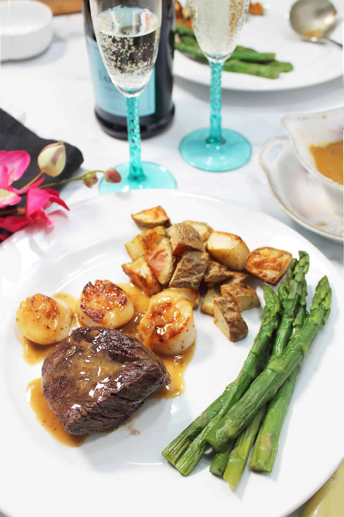 Surf and turf dinner with champagne butter sauce, asparagus and rosemary pottatoes.