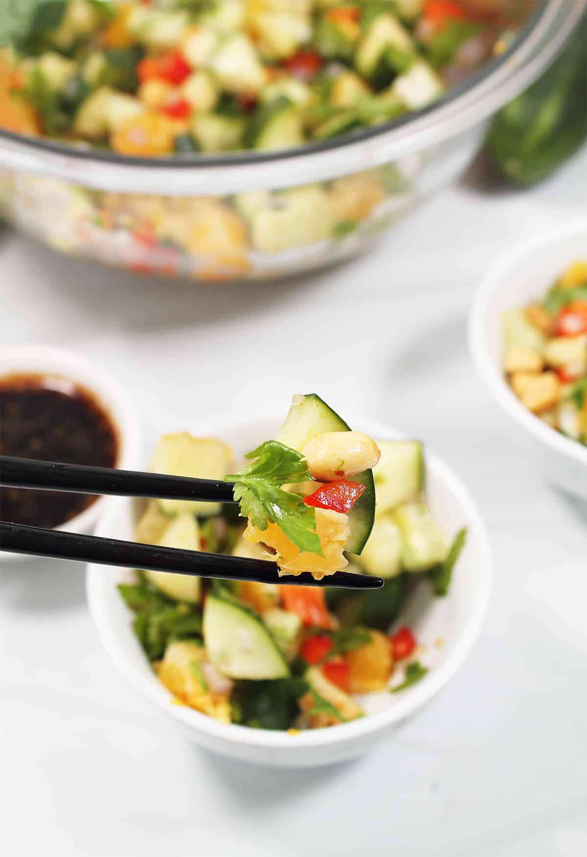 Bite of Thai cucumber salad on chopsticks.